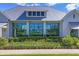 Exterior of community center with large windows and manicured landscaping at 8245 Grande Shores Dr, Sarasota, FL 34240