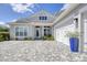 Beautiful house with a paver driveway and three-car garage, complemented by lovely landscaping at 8245 Grande Shores Dr, Sarasota, FL 34240