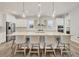 Bright kitchen features a large island with seating, stainless steel appliances, and stylish pendant lighting at 8245 Grande Shores Dr, Sarasota, FL 34240