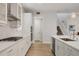 Well-lit kitchen with stainless appliances, subway tile backsplash, and a view towards the staircase at 8245 Grande Shores Dr, Sarasota, FL 34240