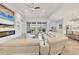 Open-concept living area featuring modern furnishings, fireplace, and seamless access to the outdoor space at 8245 Grande Shores Dr, Sarasota, FL 34240