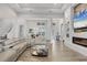 Bright and airy living area with fireplace, comfortable sectional seating, and seamless flow to other living spaces at 8245 Grande Shores Dr, Sarasota, FL 34240