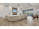 Bright living room featuring a large comfortable sectional sofa, fireplace, and sliding glass doors at 8245 Grande Shores Dr, Sarasota, FL 34240