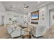 Elegant living space featuring a fireplace, comfortable seating, and sleek glass tables on wood-look tile floor at 8245 Grande Shores Dr, Sarasota, FL 34240