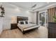 Inviting main bedroom with tray ceilings, neutral decor, and patio access at 8245 Grande Shores Dr, Sarasota, FL 34240