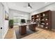 Home office with hardwood floors, a large desk, and lots of storage space provides a great place to work from home at 8245 Grande Shores Dr, Sarasota, FL 34240