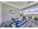 Covered outdoor seating area with patio furniture, TV and views of the pool at 8245 Grande Shores Dr, Sarasota, FL 34240