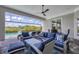 Covered outdoor seating area with views of the pool, sun loungers and lush landscaping at 8245 Grande Shores Dr, Sarasota, FL 34240