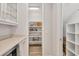 Walk-in pantry with ample shelving for storage, adjacent to kitchen area at 8245 Grande Shores Dr, Sarasota, FL 34240