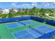 Community pickleball courts with shade structure, net, and fencing at 8245 Grande Shores Dr, Sarasota, FL 34240