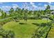 Picnic table in the community park with lush greenery and fencing at 8245 Grande Shores Dr, Sarasota, FL 34240