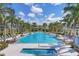 Resort-style pool with sun loungers and umbrellas offers a luxurious outdoor experience at 8245 Grande Shores Dr, Sarasota, FL 34240