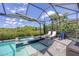 Relaxing pool area with a spa and comfortable lounge chairs under a large umbrella at 8245 Grande Shores Dr, Sarasota, FL 34240