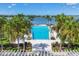 Inviting community pool with scenic lake views surrounded by lush palm trees and meticulously maintained landscaping at 8245 Grande Shores Dr, Sarasota, FL 34240
