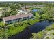 Aerial view of a building and surrounding area with a beautiful waterfront view and mature landscaping at 841 Waterside Dr # 202, Venice, FL 34285