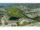 Overhead angle shows a building next to water and lush green plants surrounded by residences at 841 Waterside Dr # 202, Venice, FL 34285