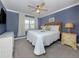 Light filled bedroom with light blue walls, plush carpeting, and elegant decor at 841 Waterside Dr # 202, Venice, FL 34285