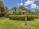 Charming home exterior featuring well-maintained landscaping and a lovely pergola at 841 Waterside Dr # 202, Venice, FL 34285