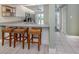Bright kitchen features counter with barstool seating and modern appliances at 841 Waterside Dr # 202, Venice, FL 34285