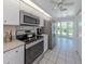Kitchen features stainless steel appliances, quartz countertops and a bay window at 841 Waterside Dr # 202, Venice, FL 34285