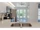 Kitchen features stainless steel appliances, quartz countertops and a bay window at 841 Waterside Dr # 202, Venice, FL 34285