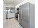 Kitchen features stainless steel appliances, white cabinetry and an open floorplan at 841 Waterside Dr # 202, Venice, FL 34285