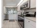 Modern kitchen with stainless steel appliances, sleek countertops, and ample cabinet space at 841 Waterside Dr # 202, Venice, FL 34285