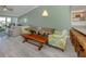 Cozy living room space with natural lighting with a dining room table and chairs next to a passthrough kitchen at 841 Waterside Dr # 202, Venice, FL 34285