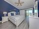 Coastal bedroom features hardwood flooring, an ensuite bathroom and lots of light at 841 Waterside Dr # 202, Venice, FL 34285