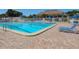 A pristine pool is surrounded by lounge chairs and greenery, offering a relaxing outdoor experience at 841 Waterside Dr # 202, Venice, FL 34285
