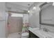 Bathroom with a tiled shower, single sink, and decorative mirror at 903 E Shannon Ct, Venice, FL 34293