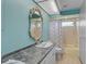 Bathroom with a shower-tub combo, single sink, and an ornate seashell mirror at 903 E Shannon Ct, Venice, FL 34293