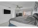 Bedroom with gray bed, large safe, TV and sliding door access to the backyard pool at 903 E Shannon Ct, Venice, FL 34293
