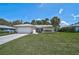 Charming single-story home with a well-manicured lawn and a classic white tiled roof at 903 E Shannon Ct, Venice, FL 34293