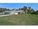 Well-maintained home with green lawn, palm tree, neutral exterior, and attached two-car garage at 903 E Shannon Ct, Venice, FL 34293