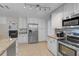 Bright and modern kitchen with stainless steel appliances and easy access to the living room at 903 E Shannon Ct, Venice, FL 34293