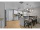 Bright kitchen with white cabinets, granite countertops, stainless appliances, and breakfast bar at 903 E Shannon Ct, Venice, FL 34293