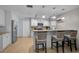 Well-lit kitchen featuring granite counters, stainless appliances, and a cozy breakfast bar at 903 E Shannon Ct, Venice, FL 34293