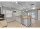 Modern kitchen with tile floors, granite countertops, white cabinets, and stainless steel dishwasher at 903 E Shannon Ct, Venice, FL 34293