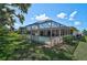 Exterior view of the screened-in pool and patio, showing proximity to the home and surrounding green lawn at 903 E Shannon Ct, Venice, FL 34293