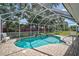 Screen enclosed in-ground pool with brick paver patio and screened enclosure, and view of the backyard at 903 E Shannon Ct, Venice, FL 34293