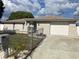 Charming single-story home featuring a decorative stone facade, long driveway, and well-maintained landscaping at 9110 Lunar Ln, Port Richey, FL 34668