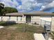 Charming single-story home featuring a decorative stone facade, fenced yard, and well-maintained landscaping at 9110 Lunar Ln, Port Richey, FL 34668