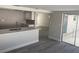 Bright kitchen features quartz countertops, tile backsplash, stainless steel faucet, and open access to adjacent living area at 9110 Lunar Ln, Port Richey, FL 34668