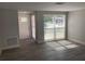 Bright living room with updated gray floors, neutral walls, and an abundance of natural light at 9110 Lunar Ln, Port Richey, FL 34668
