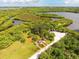 Aerial view of community kayak launch and natural surroundings including lakes and native vegetation at 935 Tidewater Shores # 721, Bradenton, FL 34208