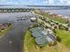 Aerial view of the community's tennis courts, marina, waterway and well-maintained landscaping at 935 Tidewater Shores # 721, Bradenton, FL 34208