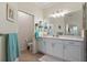 Bright bathroom with double vanity, ample counter space, large mirror and modern fixtures at 935 Tidewater Shores # 721, Bradenton, FL 34208