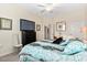 Relaxing bedroom with a ceiling fan, comfortable bed, and television for entertaining at 935 Tidewater Shores # 721, Bradenton, FL 34208
