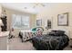 Charming bedroom featuring two twin beds with decorative pillows and ceiling fan at 935 Tidewater Shores # 721, Bradenton, FL 34208